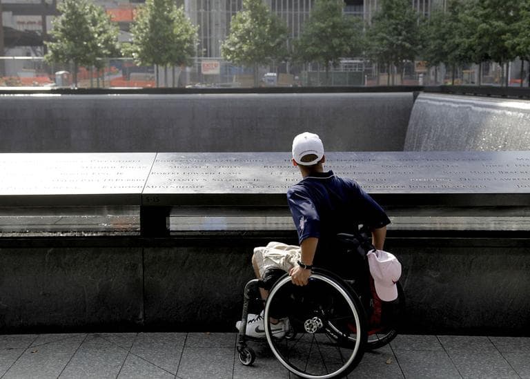 Marine Cpl. Tyler Huffman looks over a waterfall at the 9/11 Memorial in New York. (AP)
