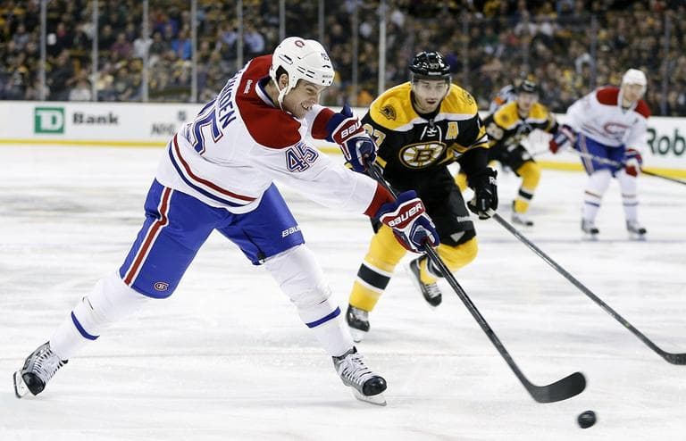 Montreal Canadiens' Michael Blunden (45) takes a shot in front of Bruins' Patrice Bergeron (37). (AP/Michael Dwyer)