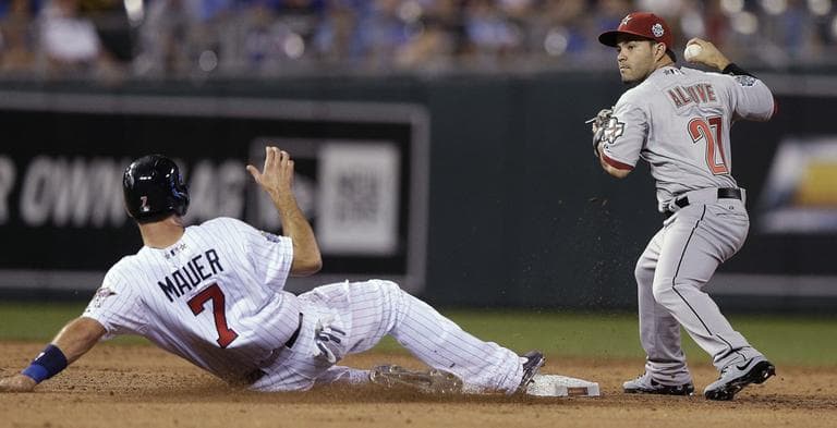 National League second baseman Jose Altuve, of the Houston Astros, forces out American League's Joe Mauer, of the Minnesota Twins, on a ground ball by Elvis Andrus, of the Texas Rangers, during the ninth inning of the MLB All-Star baseball game Tuesday, July 10, 2012. The Rangers and the Astros face off on opening day Sunday. (Charlie Riedel/AP)
