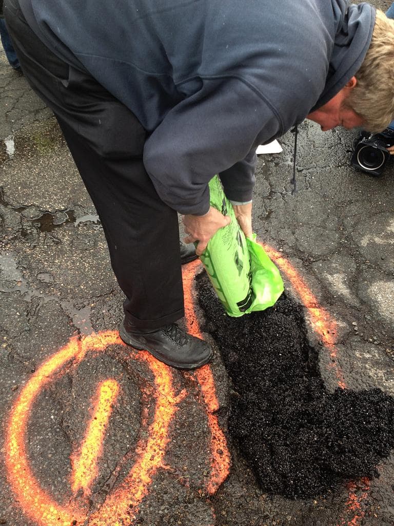 Michael Wohlfahrt, with Unique Paving Materials,  demonstrates his alternative, permanent pothole fix. (Asma Khalid/WBUR
