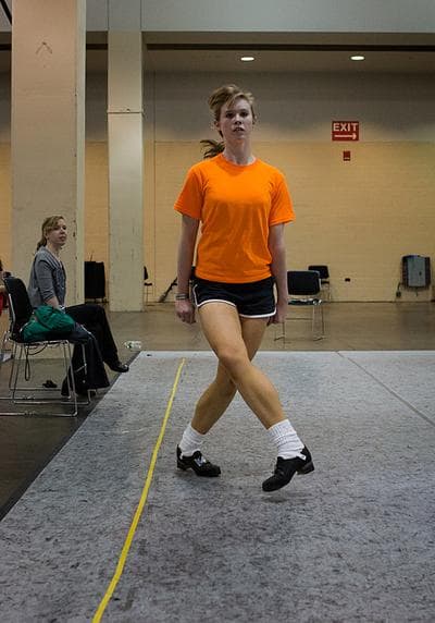 Renee Burns 16 of Rochester, NY practices on one of the many practice areas at the World Irish Dancing Championships.  (JesseCosta/WBUR)
