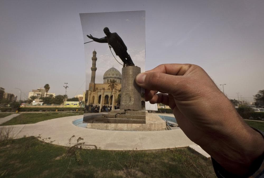 This Wednesday, March 13, 2013 photo shows a general view of Firdous Square at the site of an Associated Press photograph taken by Jerome Delay as the statue of Saddam Hussein is pulled down by U.S. forces and Iraqis on April 9, 2003. Ten years ago on live television, U.S. Marines memorably hauled down a Soviet-style statue of Saddam, symbolically ending his rule. Today, that pedestal in central Baghdad stands empty. Bent iron beams sprout from the top, and posters of anti-American Shiite cleric Muqtada al-Sadr in military fatigues are pasted on the sides.(AP Photo/Maya Alleruzzo)