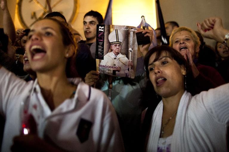 A worshiper holds up the front page of a magazine showing a photograph of Jorge Mario Bergoglio during celebrations outside the Metropolitan Cathedral in Buenos Aires, Argentina, Wednesday, March 13, 2013. (AP)