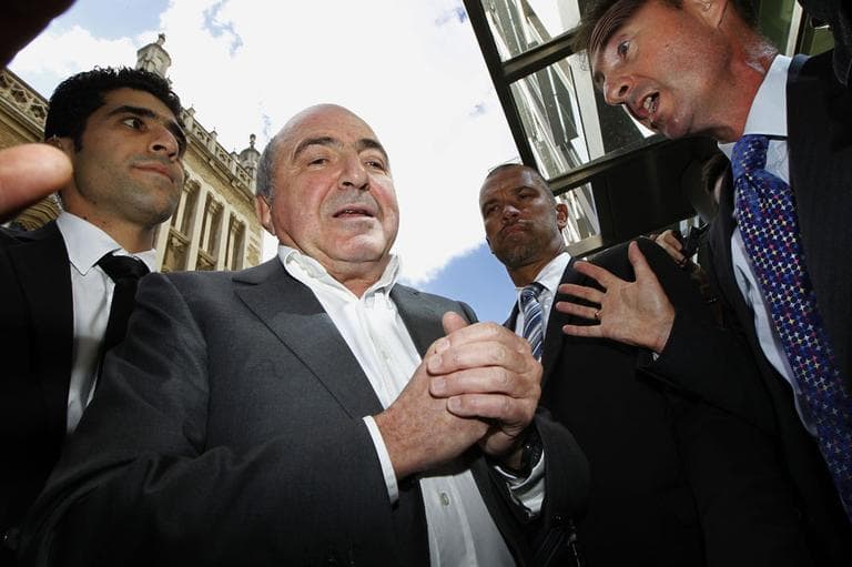 Russian tycoon Boris Berezovsky, second from left, talks to a reporter after losing his case against Russian oligarch Roman Abramovich as he leaves the High Court in London, Friday, Aug. 31, 2012. (AP)