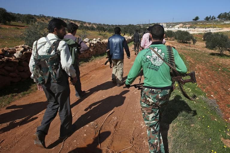 Free Syrian Army fighters from the Knights of the North brigade move to reconnaissance a Syrian army forces base of al-Karmid, at Jabal al-Zaweya, in Idlib province, Syria, Wednesday, Feb. 27, 2013. (AP)