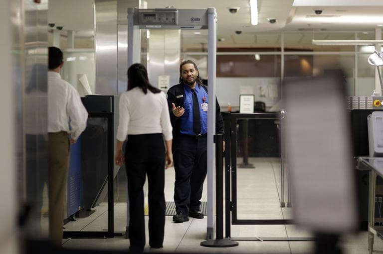 A Transportation Security Administration officer directs a traveler to step through a metal detector at a security checkpoint at Baltimore-Washington International Thurgood Marshall Airport in Linthicum, Md., Friday March, 1, 2013. (AP)