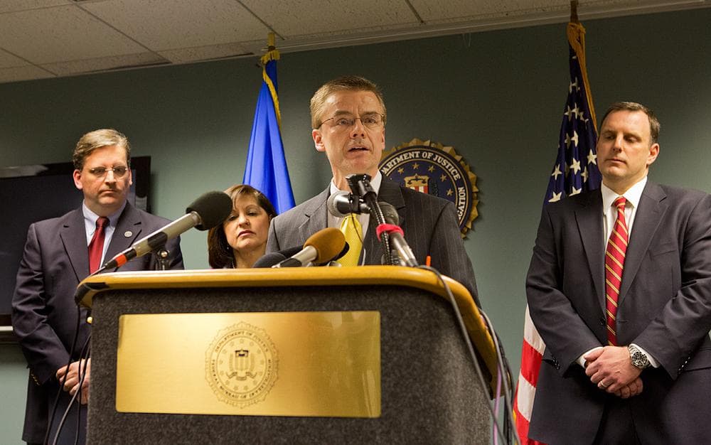 FBI Special Agent  in Charge Richard DesLauriers speaks to the press while (l-r) Chief of Security at the Isabella Stewart Gardner Museum Anthony Amore, US Attorney Carmen Ortiz, and Special Agent Geoff Kelly look on. (Jesse Costa/WBUR)