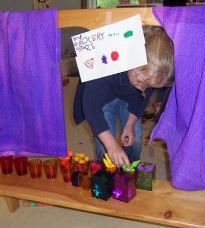 In this photo, a pre-K student plays grocery store. The author says this kind of pretend play requires more cognitive complexity than learning isolated skills. (Erika Christakis)