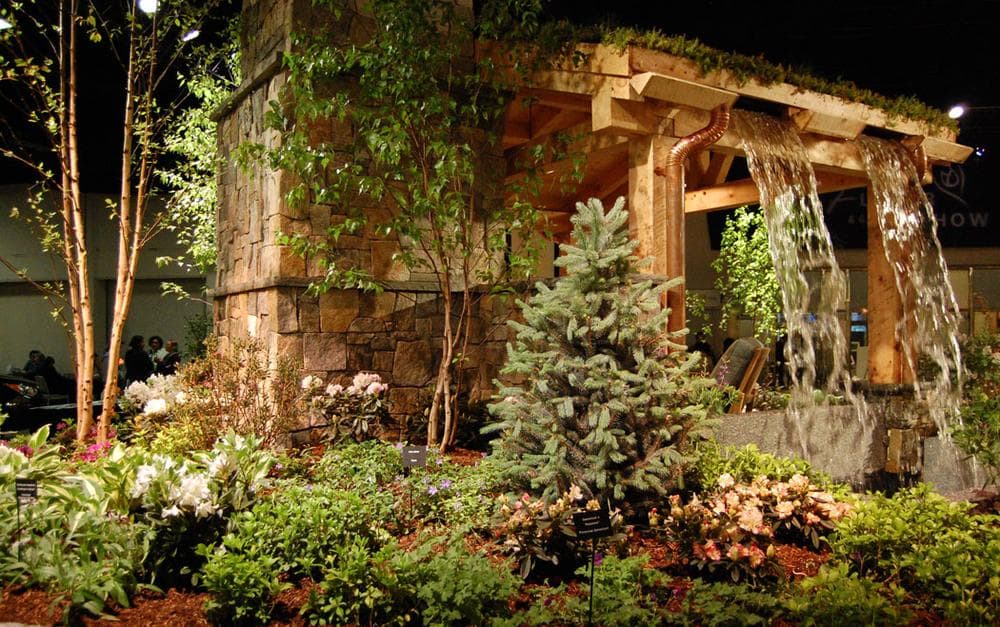 Ahronian Landscaping &amp; Design of Holliston and Medway Garden Center of Medway includes a waterfall atop outdoor seating for &quot;privacy&quot; and to &quot;drown out background noise.&quot; (Greg Cook)