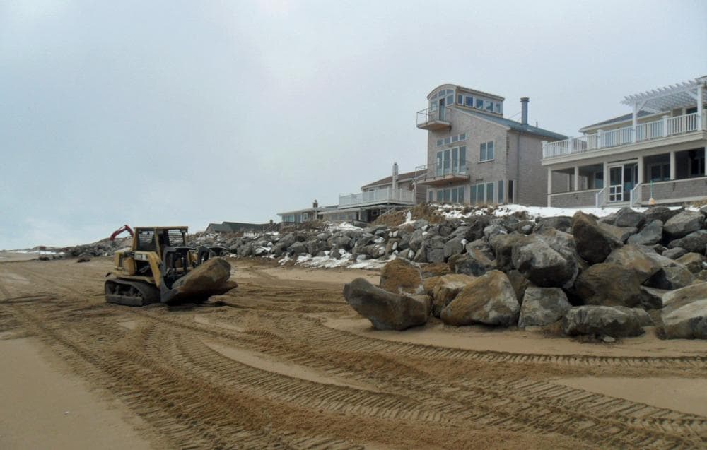 Excavators work to shore up beachfront homes on Plum Island. (Bruce Gellerman for WBUR)