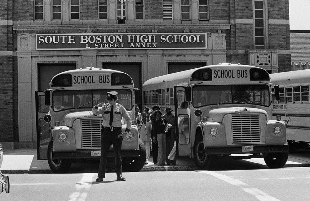 Black students of South Boston High School climb into the buses drawn right up to the school doors guarded by police, that will take them home after classes, May 30, 1975. (AP)