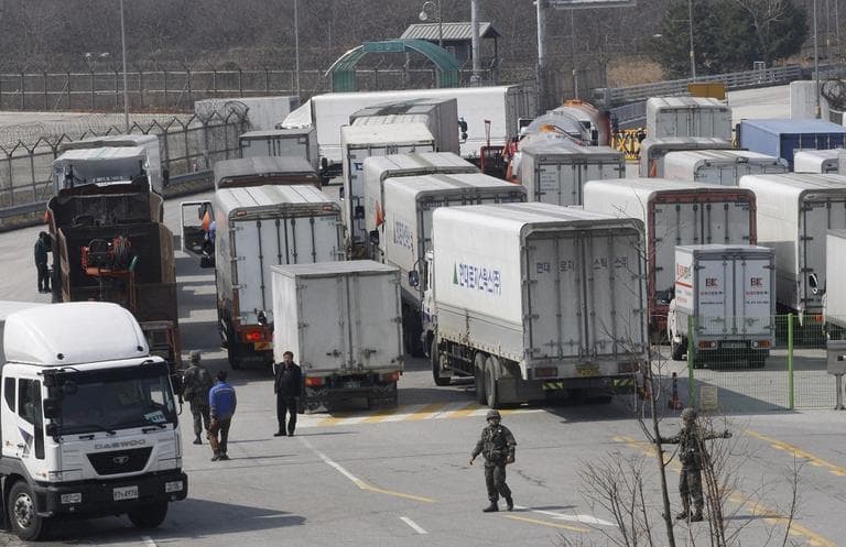 South Korean army soldiers gesture to turn back vehicles as they were refused to enter to Kaesong, North Korea, at the customs, immigration and quarantine office in Paju, South Korea, near the border village of Panmunjom, Wednesday, April 3, 2013.  (AP/Ahn Young-joon)