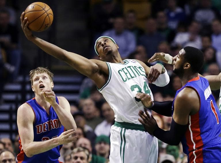 Paul Pierce stretches for a rebound against Detroit Pistons guard Kyle Singler, left, and center Andre Drummond. (AP)