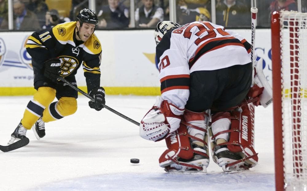 Bruins center Gregory Campbell (11) follows his shot as Devils goalie Martin Brodeur (30) makes a save in the second period of a game in Boston, Thursday, April 4, 2013. (Charles Krupa/AP)