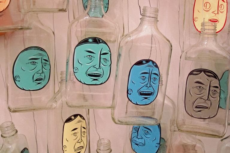 Barry McGee paid homeless men for their empty bottles and then painted these faces on them. (Andrea Shea/WBUR)