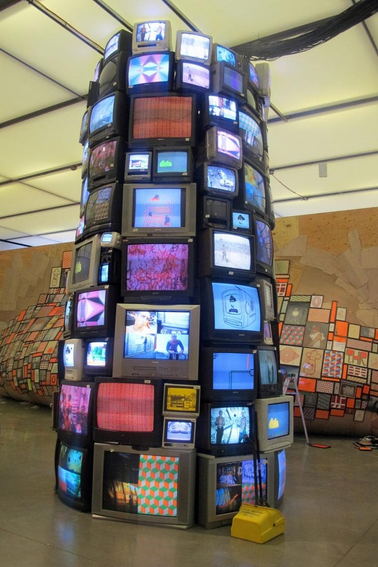 McGee collaborated with Josh Laczano for this piece, which consists of 85 televisions, 30 DVD players, electrical cords, videos and sound. They created this tower after stockpiling discarded sets as most people switched from old-format television to flat screens. (Andrea Shea/WBUR)