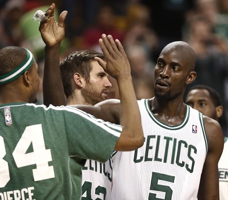 Boston Celtics' Kevin Garnett (5) is congratulated by teammate Paul Pierce. (AP/Winslow Townson)