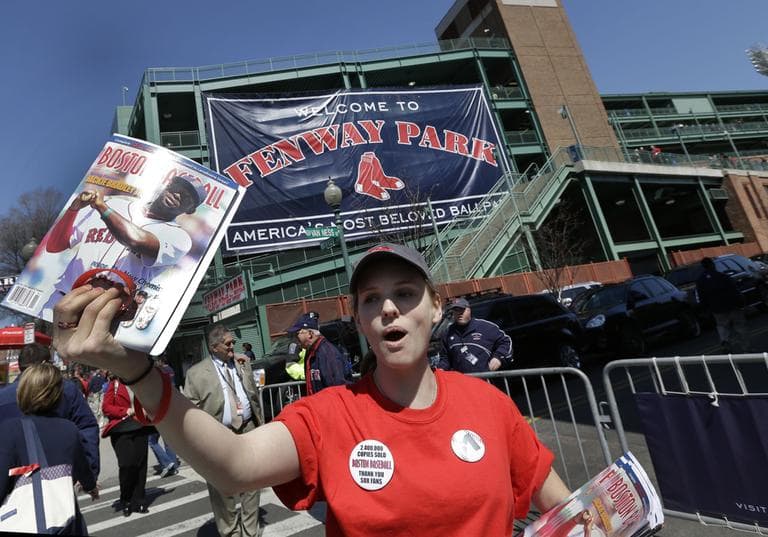 Caitlin Klinger of Somerville, Mass. sells programs outside Fenway Park prior to a baseball game at between the Boston Red Sox and the Baltimore Orioles in Boston, Monday, April 8, 2013. (Elise Amendola/AP)
