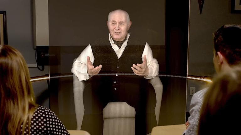 A hologram of Holocaust survivor Pinchas Gutter interacts with onlookers during a demonstration of the New Dimensions in Technology project. (USC Institute for Creative Technologies)