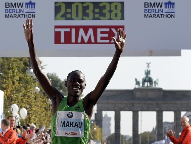 Patrick Makau from Kenya crosses the finish line to win the 38th Berlin Marathon in Berlin, Germany, Sunday, Sept. 25, 2011 in a new world record time of 2 hours, 3 minutes, 38 seconds. (Michael Sohn/AP)