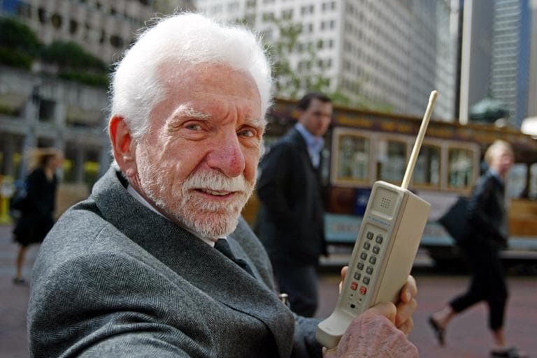 Martin Cooper, chairman and CEO of ArrayComm, is pictured in 2003 holding a Motorola DynaTAC, a 1973 prototype of the first handheld cellular telephone. (Eric Risberg/AP)
