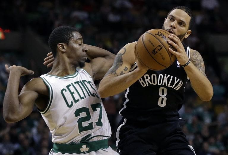 Brooklyn Nets point guard Deron Williams (8) shoots and is fouled by Boston Celtics guard Jordan Crawford. (AP/Elise Amendola)