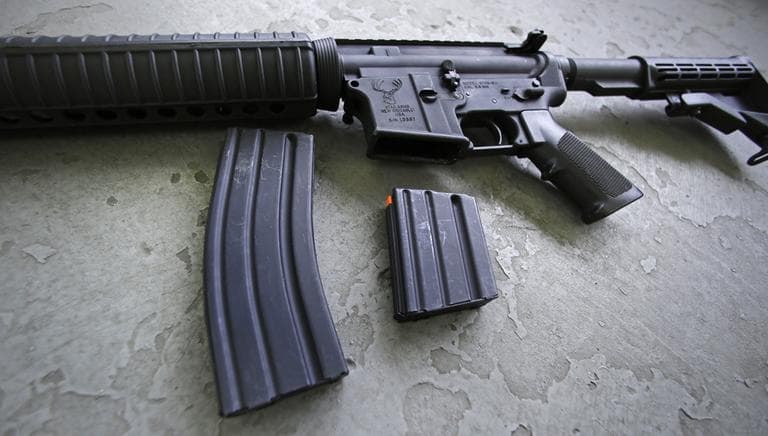 A 30-round magazine, left, and a 10-round magazine, right, rest below an AR-15 rifle at the Ammunition Storage Component company in New Britian, Conn., Wednesday, April 10, 2013. In the wake of Connecticut lawmaker's vote to ban high-capacity magazines after their passage of restrictive gun control law, the U.S. Senate is debating gun control legislation. (Charles Krupa/AP)