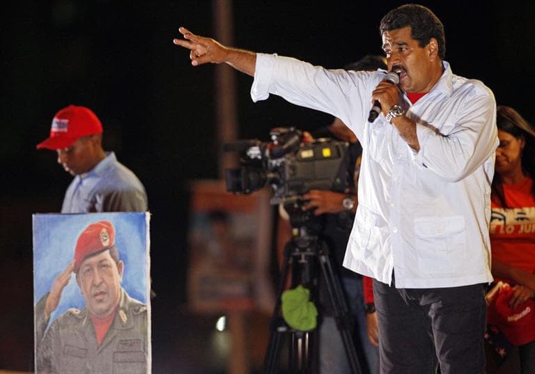 Venezuela's acting President Nicolas Maduro speaks during his closing campaign rally in Caracas, Venezuela, Thursday, April 11, 2013. Maduro, the hand-picked successor of Venezuela's late President Hugo Chavez whose portrait stands at left, is running for president against opposition candidate Henrique Capriles on April 14. (Ramon Espinosa/AP)
