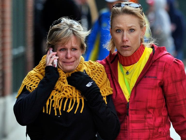 Women react as they walk from the area where there was an explosion after the Boston Marathon in Boston, Monday, April 15, 2013. (Josh Reynolds/AP)