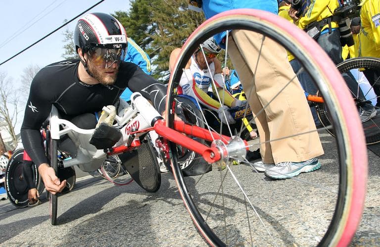 Defending champion Josh Cassidy, of Canada, adjusts his wheelchair prior to the wheelchair division start of the 117th running of the Boston Marathon, in Hopkinton, Mass., Monday, April 15, 2013. (Stew Milne/AP)