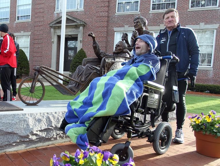 Dick Hoyt, right, and his son, Rick, stand next to a statue honoring them near the start of the 117th running of the Boston Marathon, in Hopkinton, Mass., Monday, April 15, 2013. (Stew Milne/AP)