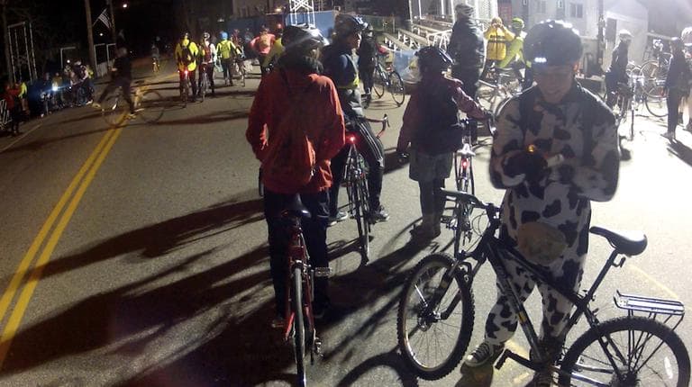 Midnight marathon cyclist Chris Nolan waits by his bike before the 26.2 mile ride from Hopkington, Mass. to Boston begins. (Nate Goldman/WBUR)