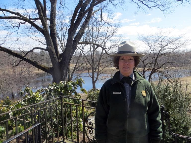 National Park Service Superintendent Nancy Nelson stands along the banks of the Concord River. (Bruce Gellerman/WBUR)