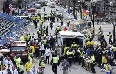 Medical workers aid injured people at the finish line of the 2013 Boston Marathon following an explosion in Boston, Monday, April 15, 2013. (Charles Krupa/AP)
