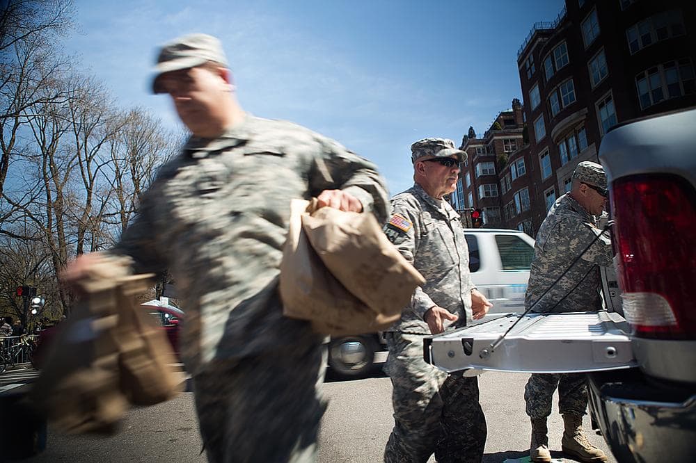 Army National Guardsmen unload packed lunches for security personnel working on and around the Boylston Street crime scene. (Jesse Costa/WBUR)