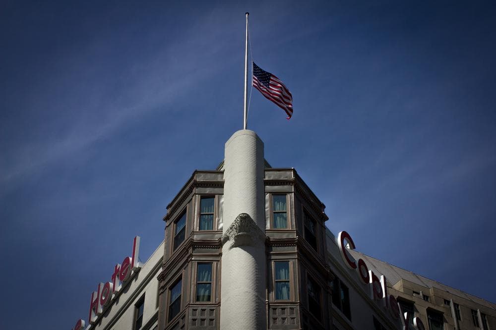 Flag at half-mast on the Copley Square Hotel. (Joe Spurr/WBUR)