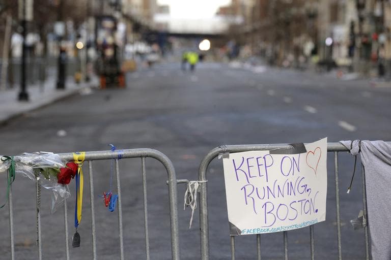 A sign hangs from a barricade  on Boylston Street near the finish line of the Boston Marathon, Wednesday, April 17, 2013, in Boston. (Julio Cortez/AP)