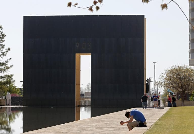 Shane Magness, a student at Oklahoma Christian University, bows his head in prayer for the victims of the Boston Marathon bombing, at the Oklahoma City National Memorial in Oklahoma City, Monday, April 15, 2013. (Sue Ogrocki/AP)