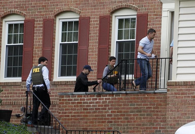FBI agents escort Ruslan Tsarni, uncle of the Boston Marathon bombing suspects, second from right, into his home in Montgomery Village in Md. Friday, April, 19, 2013. (Jose Luis Magana/AP)