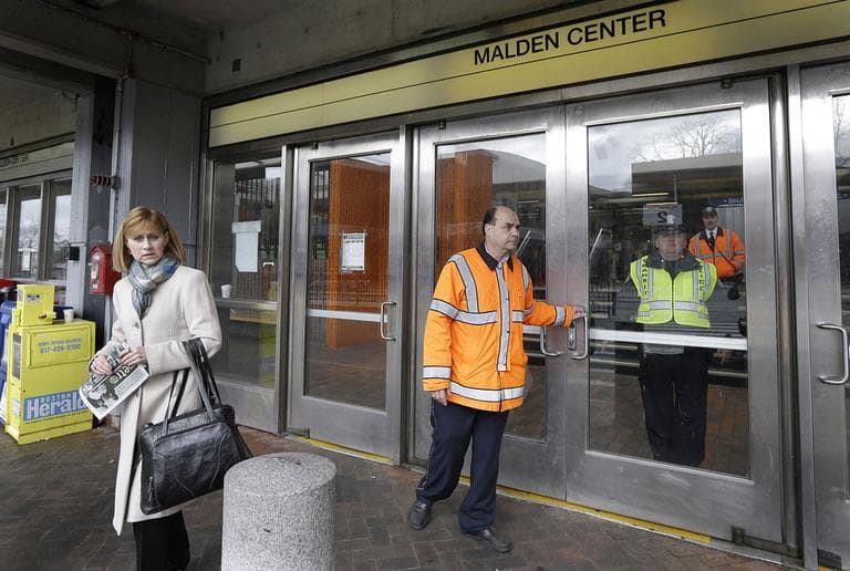MBTA transit police turn away a commuter at Malden Center station in Malden, Mass. Friday, April 18, 2013 as area MBTA commuter trains are suspended. (Elise Amendola/AP)