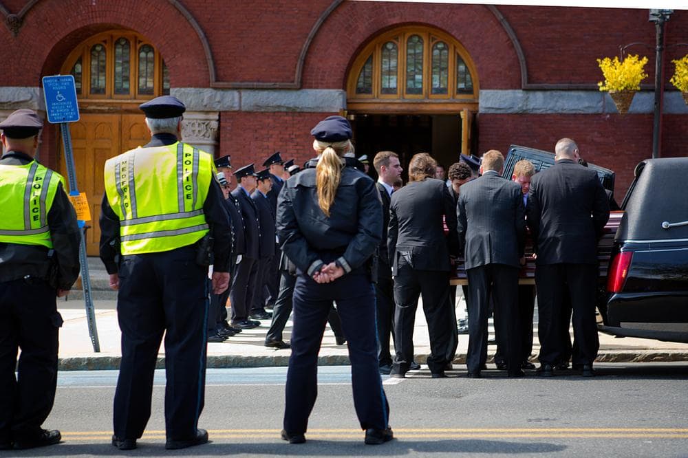 Pallbearers remove Krystle Campbell's casket from a hearse to be carried into St. Joseph's Church. (Jesse Costa/WBUR)