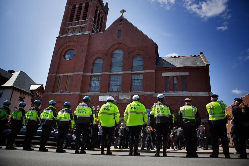 Police line up outside of St. Joseph's Church. (Jesse Costa/WBUR)