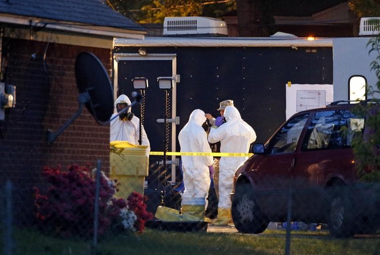 Federal authorities wear hazmat suits as they search the home of Everett Dutschke, Tuesday, April 23, 2013 in Tupelo, Miss., in connection with the recent ricin attacks. (Rogelio V. Solis/AP)