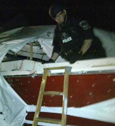 This photo provided by the Revere Police Department shows Revere Police Chief Joseph Cafarelli clearing Henneberry’s boat moments after Dzhokhar Tsarnaev was apprehended. (AP)