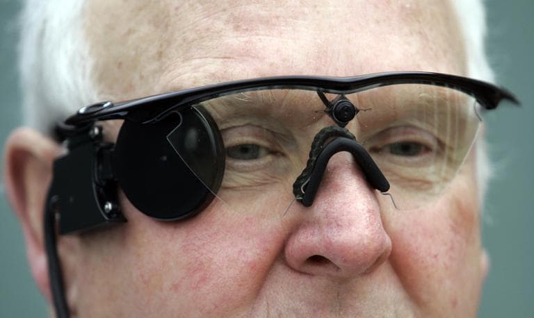 Eric Selby poses for a photograph in Coventry, England, in February 2011. He's wearing a &quot;sight&quot; camera fitted in a pair of glasses, which works in conjunction with an artificial retina implant called the Argus II fitted in his right eye, enabling him to detect light. (Martin Cleaver/AP)