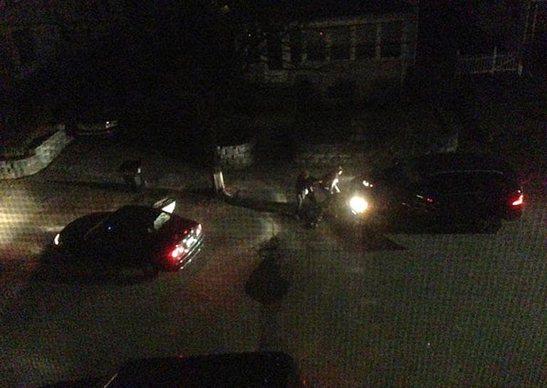 Watertown resident Andrew Kitzenberg took this photo from his window at 12:48 a.m. on Friday. Authorities say the Tsarnaev brothers fired on Watertown officers from behind the Mercedes SUV they stole in a carjacking. (Andrew Kitzenberg/getonhand.com)