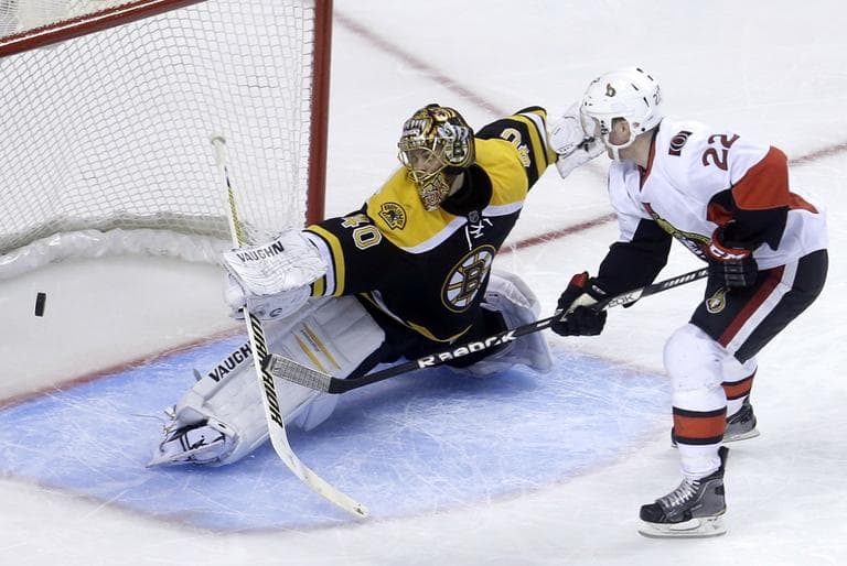 Bruins goalie Tuukka Rask (40), of Finland, left, deflects a shot on goal by Ottawa Senators right wing Erik Condra (22). (AP/Steven Senne)