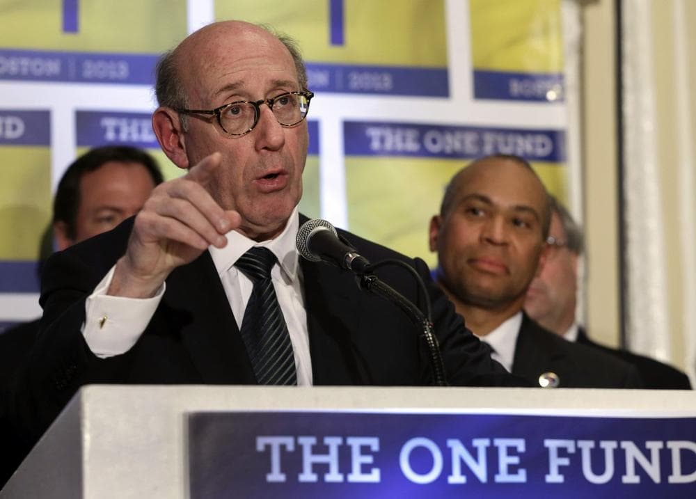 Kenneth Feinberg, an attorney who managed the 9/11 Victim Compensation Fund, speaks at a news conference in Boston on April 23, 2013, as Massachusetts Gov. Deval Patrick listens at right. Feinberg will design and be administrator of a new fund to help people affected by the Boston Marathon bombing. (Elise Amendola/AP)