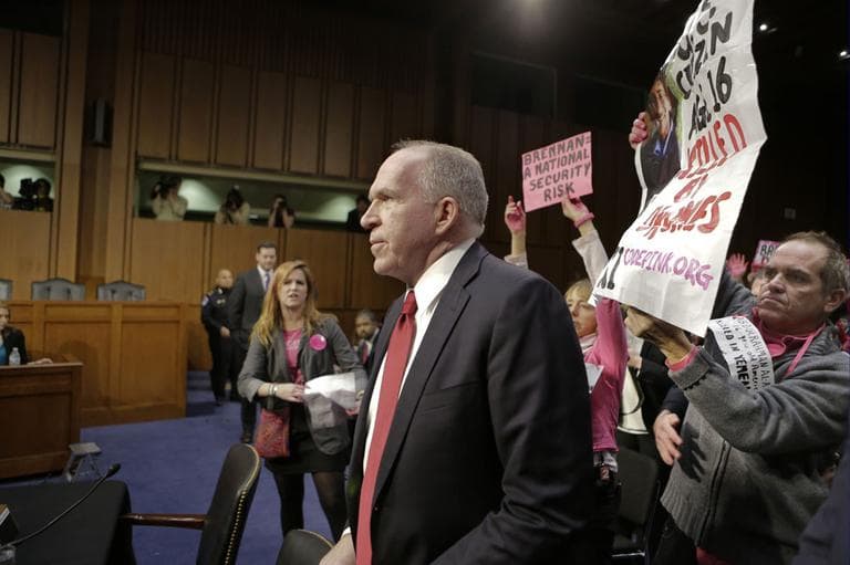 Protesters from CODEPINK, a group opposed to U.S. militarism, including co-founder Medea Benjamin, center, disrupt the start of the Senate Intelligence Committee confirmation hearing for John Brennan, Thursday, Feb. 7, 2013, on Capitol Hill in Washington. (AP)
