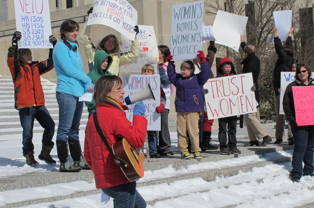 Kris Kitko leads chants of protest at an abortion-rights rally at the state Capitol in Bismarck, N.D., on Monday, March 25, 2013. More than 300 demonstrators attended the rally protesting a package of measures that would give the state the toughest abortion restrictions in the nation. (AP)
